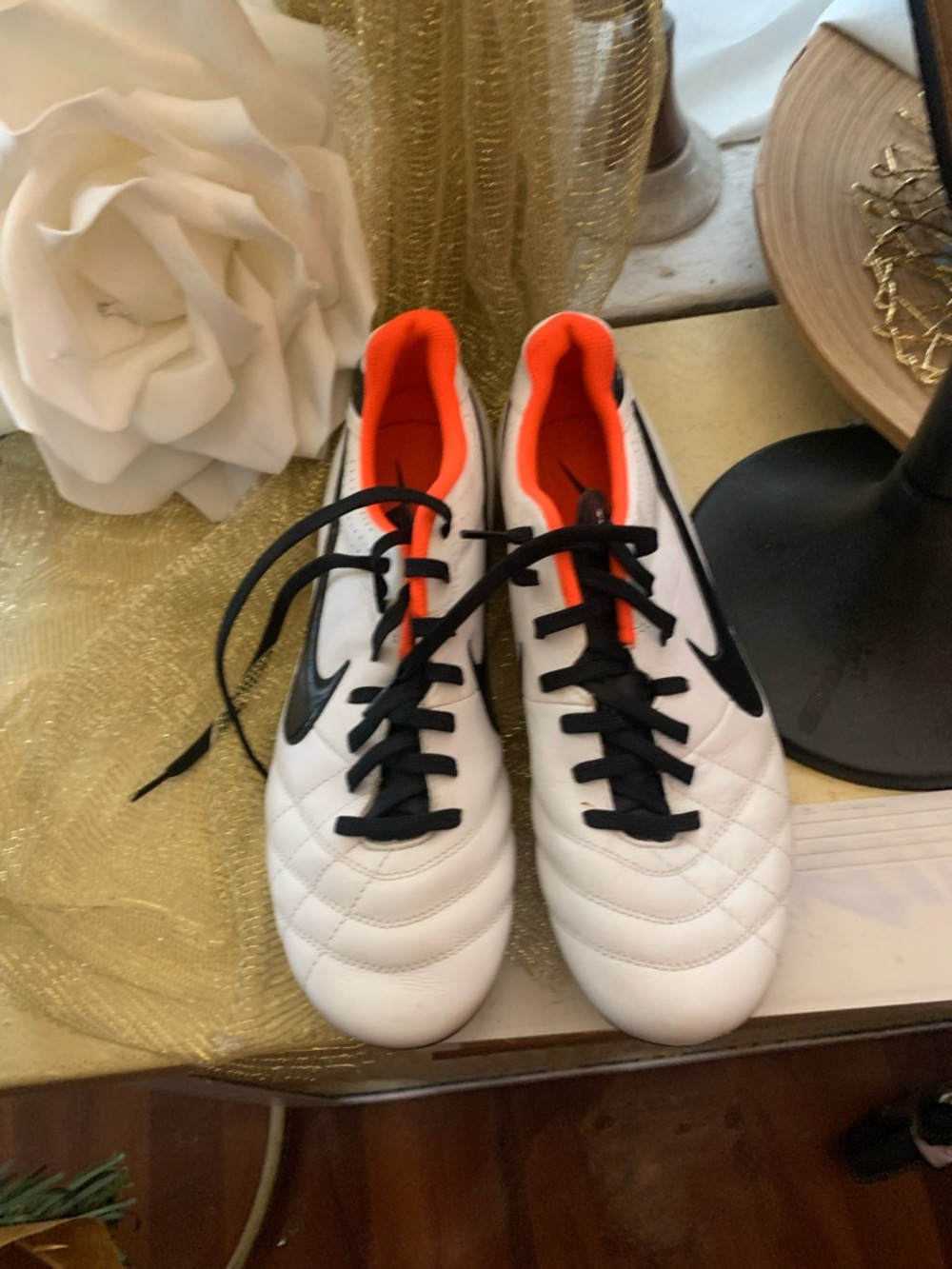 Nike White Soccer Cleats with Black Swoosh and Orange Interior